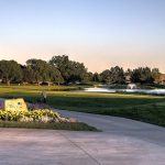 Panoramic view of a lush green golf course at Oak Hills Country Club. Smooth