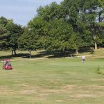 Panoramic view of a lush green golf course at Oak Hills Par 30 Public Golf Course. Smooth