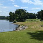 Panoramic view of a lush green golf course at Oak Hollow Golf Course. Smooth