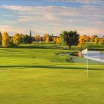 Panoramic view of a lush green golf course at Oak Marsh Golf Course and Event Center. Smooth