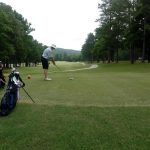green grass with the flag in the hole.