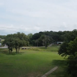 Panoramic view of a lush green golf course at Oak Park Golf & Recreation. Smooth