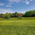 Panoramic view of a lush green golf course at Oak Ridge Golf Club. Smooth