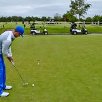 green grass with the flag in the hole.