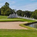 Panoramic view of a lush green golf course at Oak Tree Country Club. Smooth