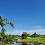 Panoramic view of a lush green golf course at Oak Tree National. Smooth