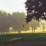Panoramic view of a lush green golf course at Oakdale Golf Club. Smooth