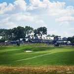 Panoramic view of a lush green golf course at Oakmont Country Club. Smooth