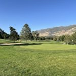 Panoramic view of a lush green golf course at Oakridge Country Club. Smooth