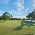 Panoramic view of a lush green golf course at Oakwing Golf Club. Smooth