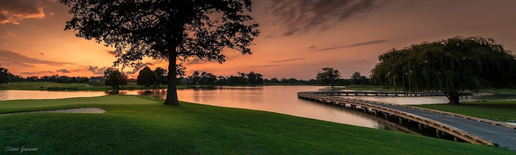 Panoramic view of a lush green golf course at Oasis Golf Club. Smooth