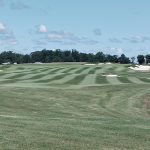 Panoramic view of a lush green golf course at Occano. Smooth