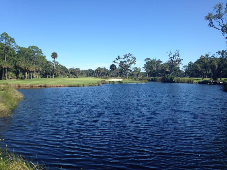 Panoramic view of a lush green golf course at Ocean Creek Golf Course. Smooth