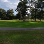 Panoramic view of a lush green golf course at Ocean View Golf Course. Smooth