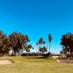 Panoramic view of a lush green golf course at Oceanside Golf Course. Smooth