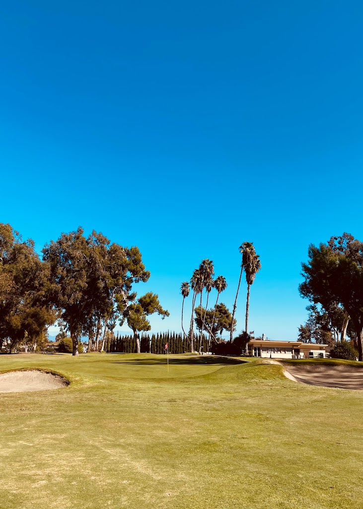 Panoramic view of a lush green golf course at Oceanside Golf Course. Smooth