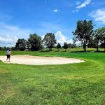 Panoramic view of a lush green golf course at Old Bridge Golf Club. Smooth