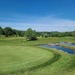 Panoramic view of a lush green golf course at Old Capital Golf Club. Smooth