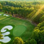Panoramic view of a lush green golf course at Old Chatham Golf Club. Smooth