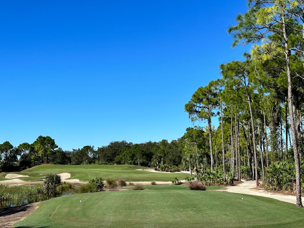 Panoramic view of a lush green golf course at Old Corkscrew Golf Course. Smooth