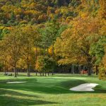 Panoramic view of a lush green golf course at Old Course at The Omni Homestead Resort & Spa. Smooth
