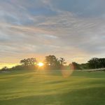Panoramic view of a lush green golf course at Old Elm Club. Smooth