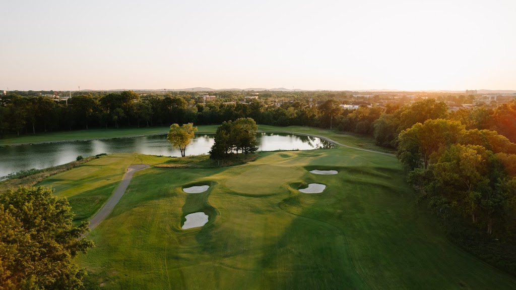Panoramic view of a lush green golf course at Old Fort Golf Course. Smooth