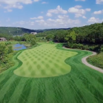 Panoramic view of a lush green golf course at Old Kinderhook Golf Course. Smooth