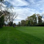 Panoramic view of a lush green golf course at Old Oak Country Club. Smooth