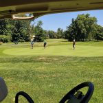 green grass with the flag in the hole.