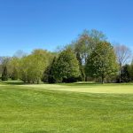 Panoramic view of a lush green golf course at Old Tappan Golf Course. Smooth