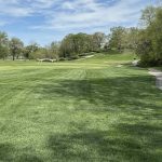 Panoramic view of a lush green golf course at Old Warson Country Club. Smooth