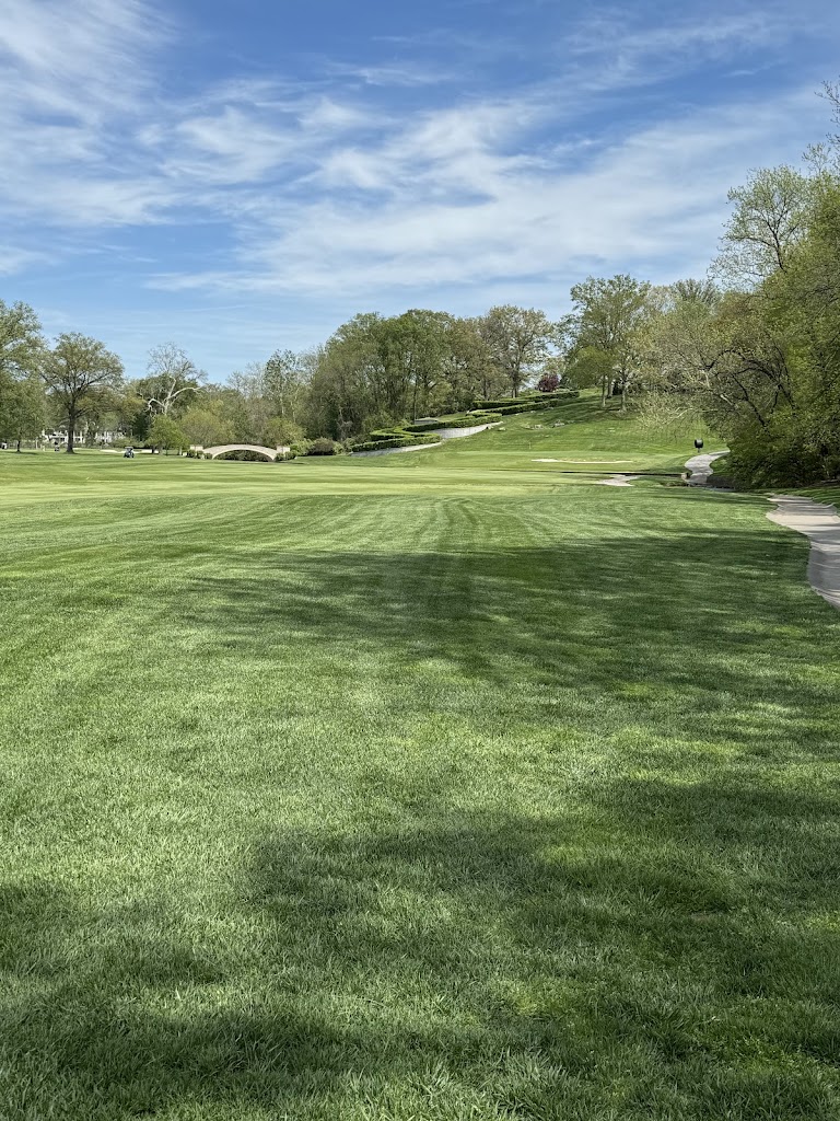 Panoramic view of a lush green golf course at Old Warson Country Club. Smooth