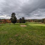 Panoramic view of a lush green golf course at Olde Salem Greens Golf Course. Smooth