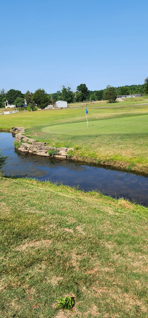 Panoramic view of a lush green golf course at Olde White Oaks Golf Course. Smooth
