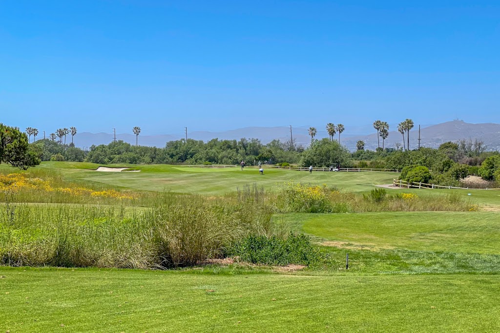 Panoramic view of a lush green golf course at Olivas Links. Smooth