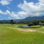 Panoramic view of a lush green golf course at Olomana Golf Links. Smooth