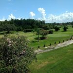 Panoramic view of a lush green golf course at On Top of the World Golf Course. Smooth