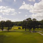 Panoramic view of a lush green golf course at Oneida Municipal Golf Course. Smooth