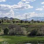 Panoramic view of a lush green golf course at Oquirrh Hills Golf Course. Smooth