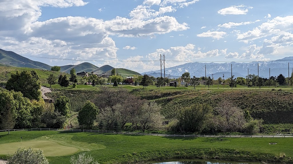Panoramic view of a lush green golf course at Oquirrh Hills Golf Course. Smooth