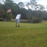 green grass with the flag in the hole.