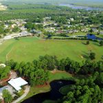 Panoramic view of a lush green golf course at Orange Beach Golf Center. Smooth