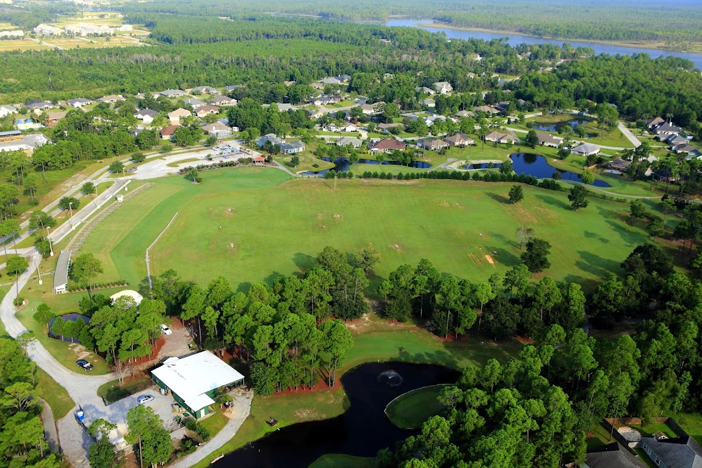 Panoramic view of a lush green golf course at Orange Beach Golf Center. Smooth
