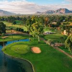 Panoramic view of a lush green golf course at Orange Tree Golf Resort