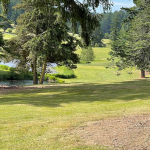 Panoramic view of a lush green golf course at Orcas Island Golf Course. Smooth