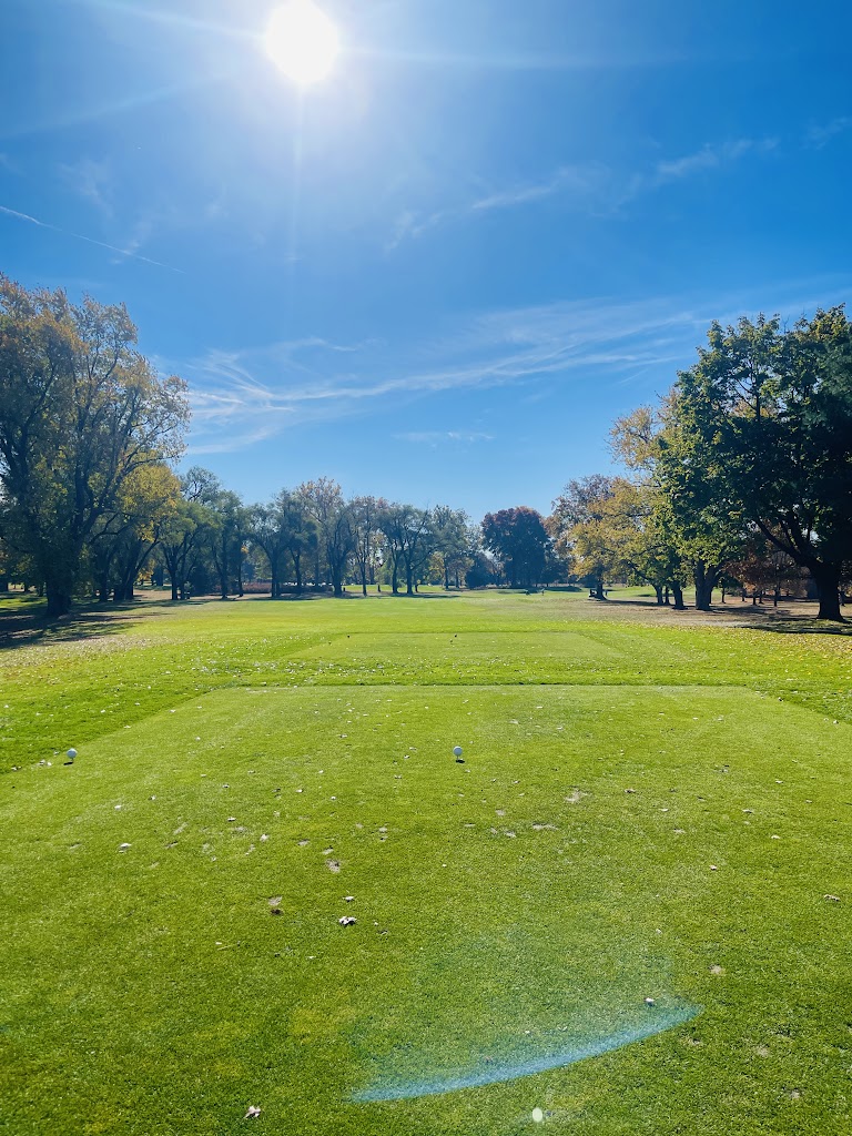 Panoramic view of a lush green golf course at Orchard Hills Golf Course. Smooth