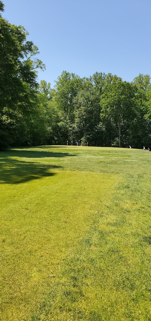 Panoramic view of a lush green golf course at Orchards Golf Course. Smooth