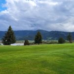 Panoramic view of a lush green golf course at Oregon Trail Country Club. Smooth