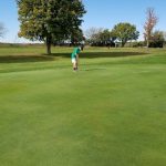 Panoramic view of a lush green golf course at Osawatomie Golf Course. Smooth
